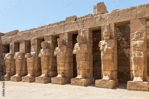 The statues of Pharaoh Ramses III as Osiris guarding the precinct of the temple of Karnak, Luxor, Egypt.