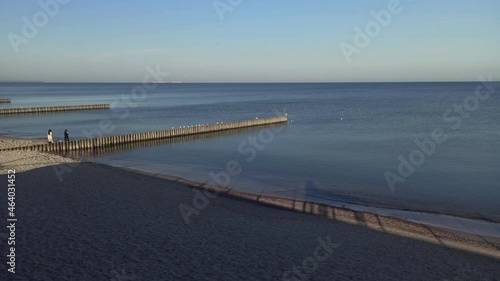 Wallpaper Mural a bridge on the beach by the sea on which the waves come  Torontodigital.ca