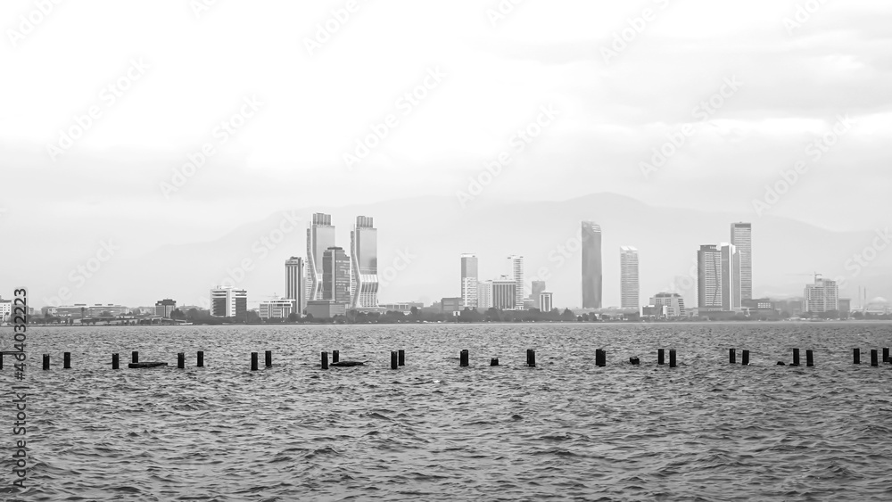 Obraz premium A landscape of Izmir with old pier, black and white photograph. 