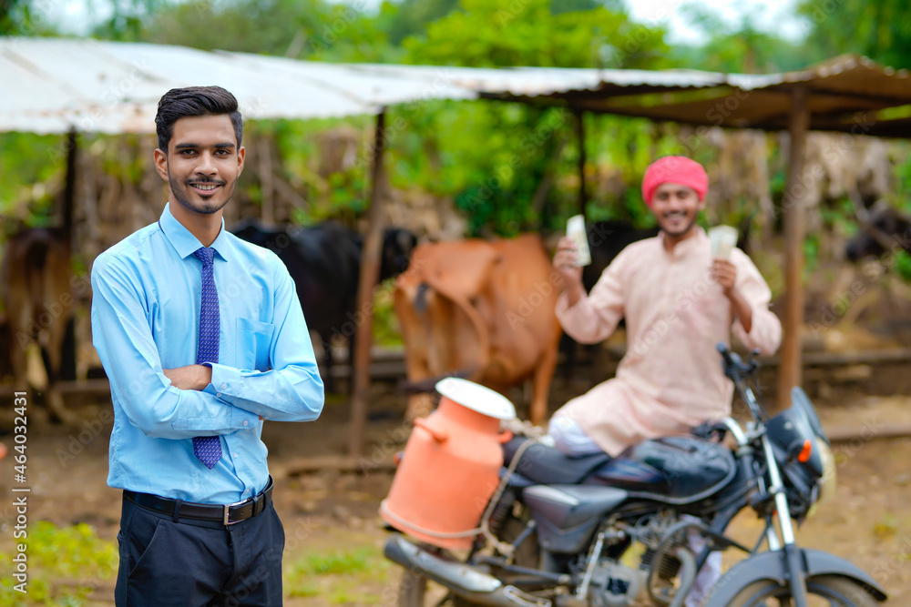 Indian farmer with agronomist at his cattle farm