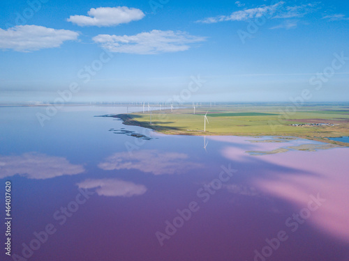 Fototapeta Naklejka Na Ścianę i Meble -  Amazing aerial view of windmills near the pink lake