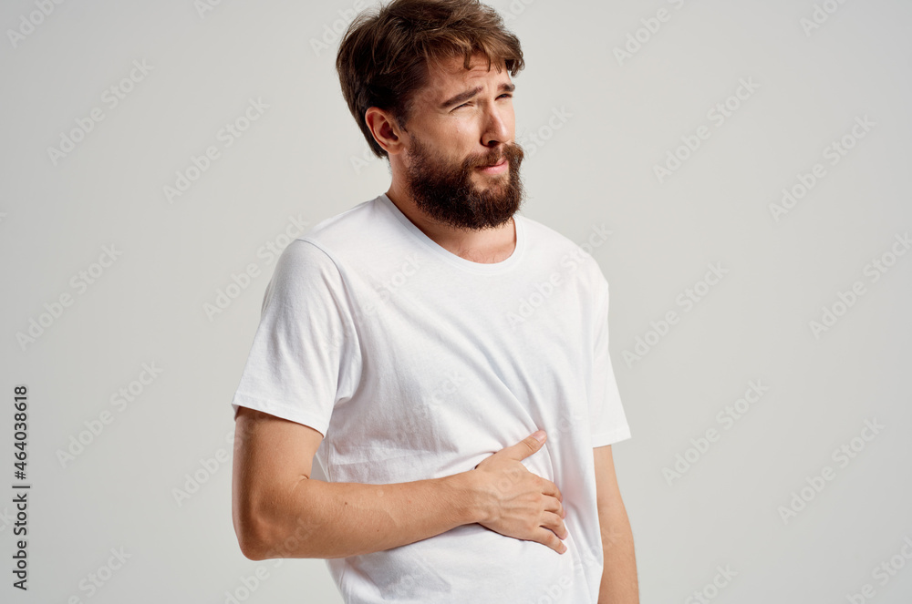 man wearing white t-shirt abdominal pain diarrhea medicine health problems man wearing white t-shirt abdominal pain diarrhea medicine health problems