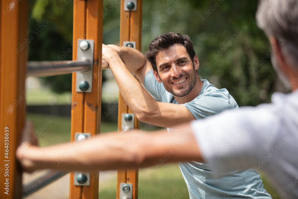 two confident attractive sportsmen during workout outdoors two confident attractive sportsmen during workout outdoors