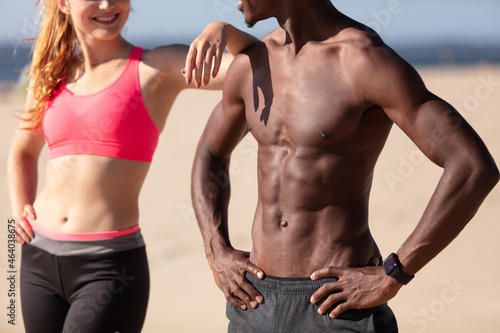 portrait of fit young man and woman at the beach