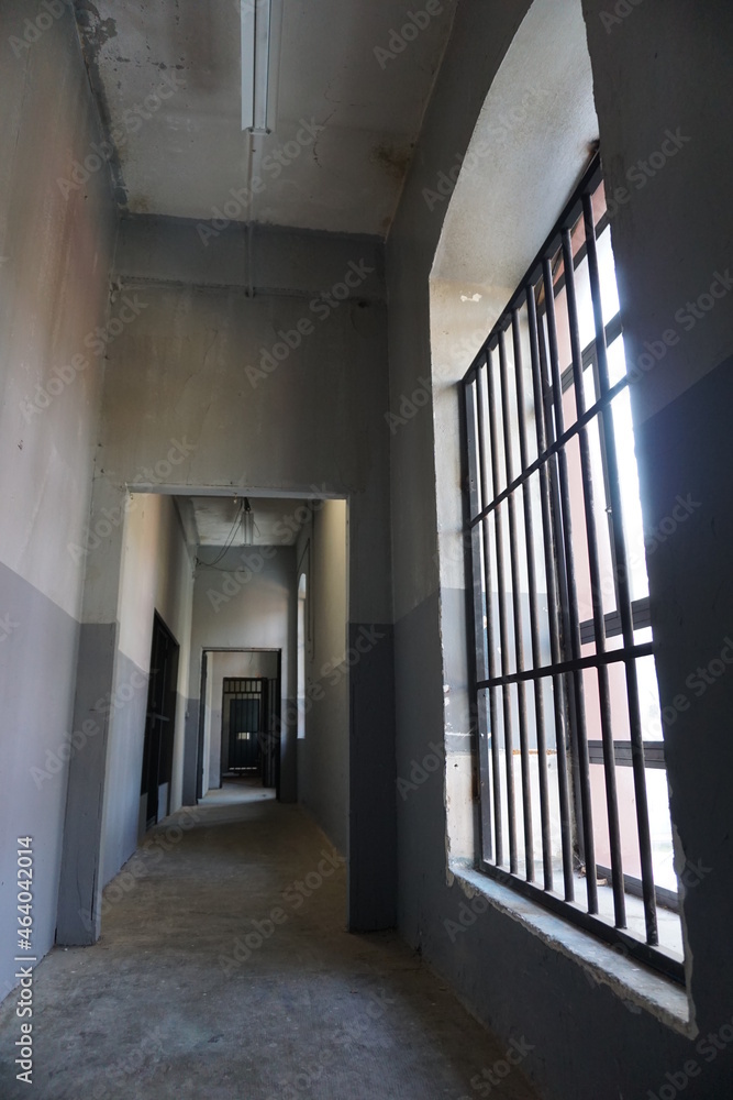 iron bars and empty prison corridors