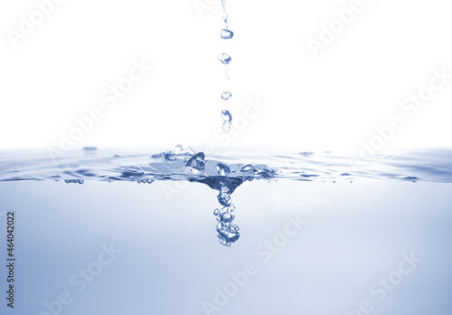 Water splash Aqua flowing in waves and creating bubbles Drops on the water surface feel fresh and clean isolated on white background.