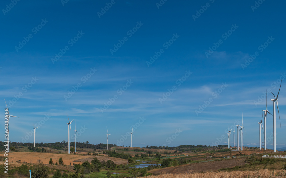 Wind turbines generating electricity over blue sky Wind turbines generating electricity over blue sky