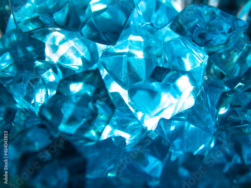 Bright blue crystals made of glass look like gems close-up in the blur. Background from blue stones crystals. © Oleksandr Kliuiko