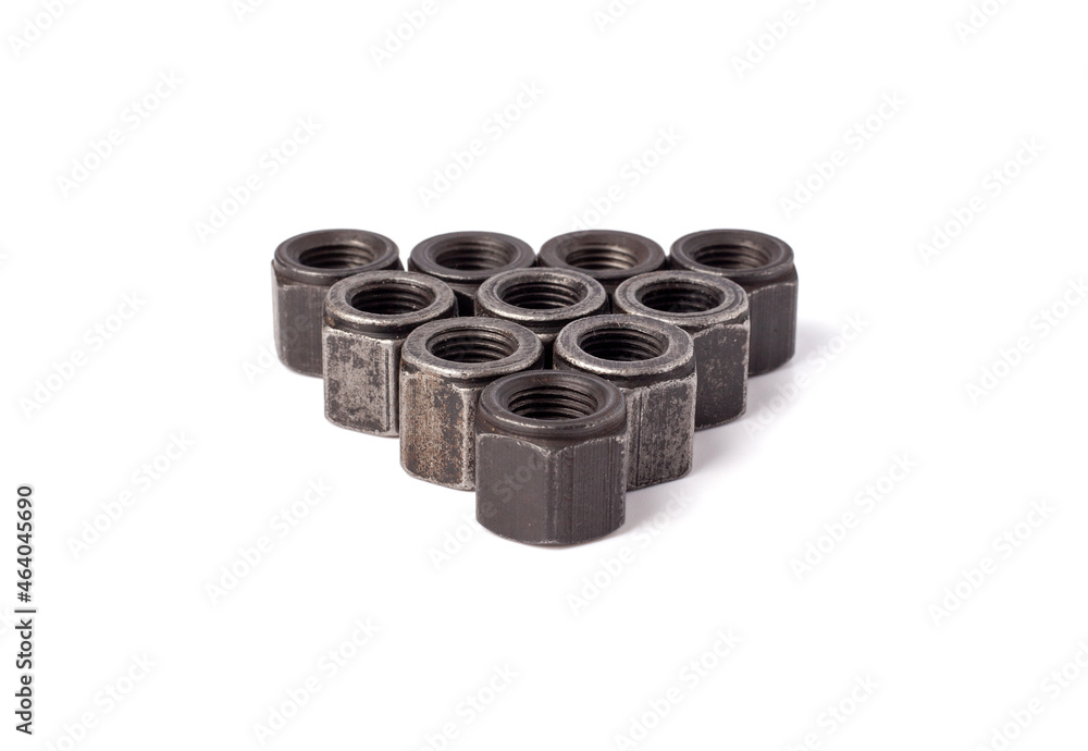 stack of metallic nuts isolated on white background. Heavy hex nut. Female screw nut with copy space. Fastener stack of metallic nuts isolated on white background. Heavy hex nut. Female screw nut with copy space. Fastener