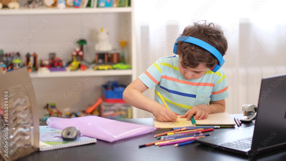 Learn on your schedule. Distance learning online education. A schoolboy boy studies at home and does school homework. A home distance learning. Learn on your schedule. Distance learning online education. A schoolboy boy studies at home and does school homework. A home distance learning.