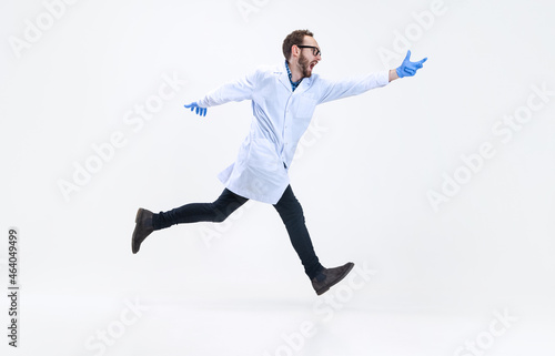 Portrait of running man, chemist, doctor in action and motion isolated on white background. Concept of healthcare, pharmaceuticals, medicine