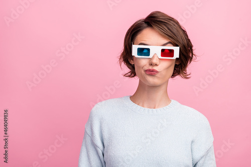 Photo of doubtful lady think look empty space wear 3d glasses blue sweater isolated pink color background © deagreez