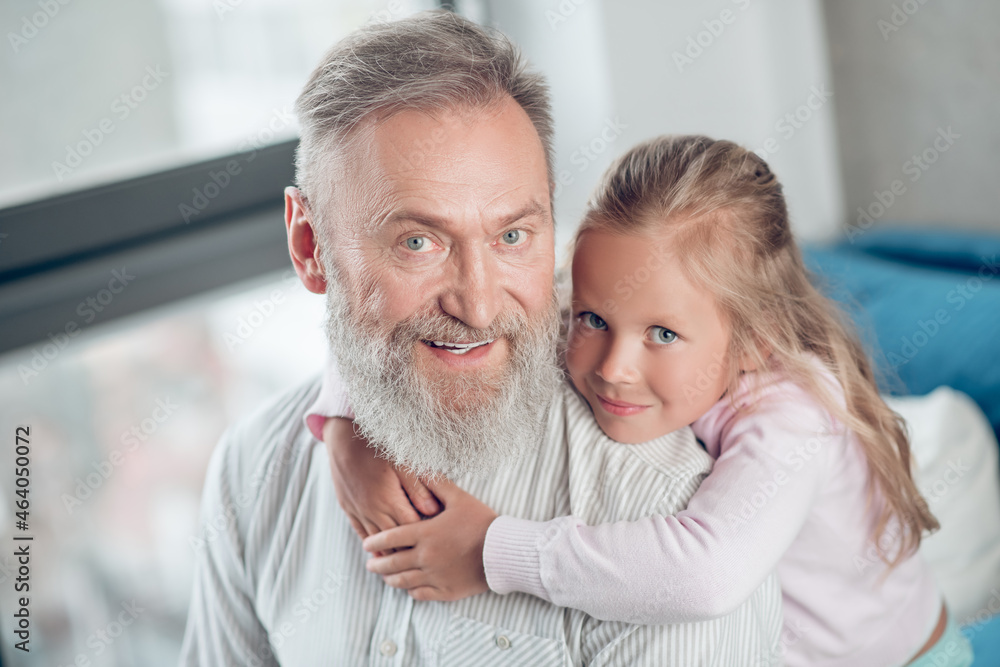A small cute girl looking happy spending time with her father A small cute girl looking happy spending time with her father