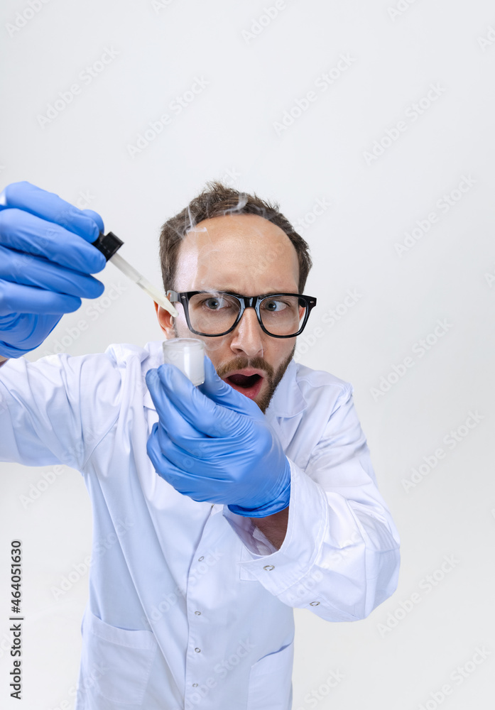 Close-up young chemist, doctor or student conducts chemical research isolated on white background. Concept of pharmacology. Close-up young chemist, doctor or student conducts chemical research isolated on white background. Concept of pharmacology.
