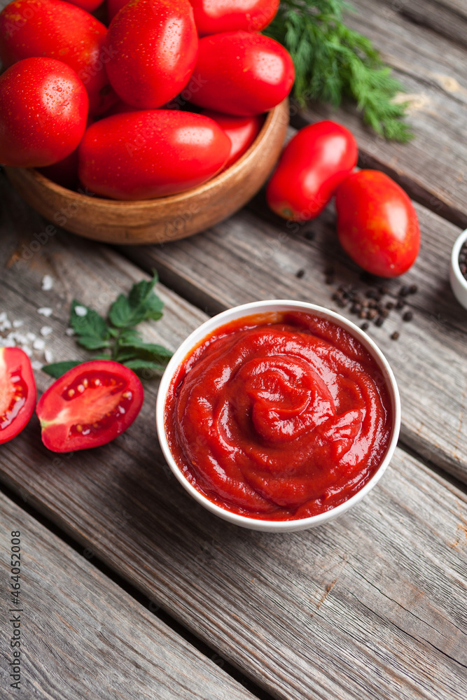 Homemade tomato sauce in white bowl, fresh tomatoes, spices and herbs. Food background Homemade tomato sauce in white bowl, fresh tomatoes, spices and herbs. Food background