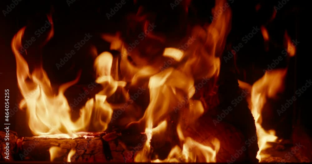 Close up of Hot Burning Fire Flame in Glass Fireplace with Wood in Dark Room at Night. Cozy Warm Winter Background or Wild nature Element concept. 4K static shot Close up of Hot Burning Fire Flame in Glass Fireplace with Wood in Dark Room at Night. Cozy Warm Winter Background or Wild nature Element concept. 4K static shot