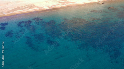 Aerial view of the ocean surface with clear water