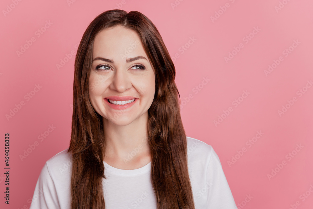 Portrait of curious positive girl shiny smile look empty space on pink background