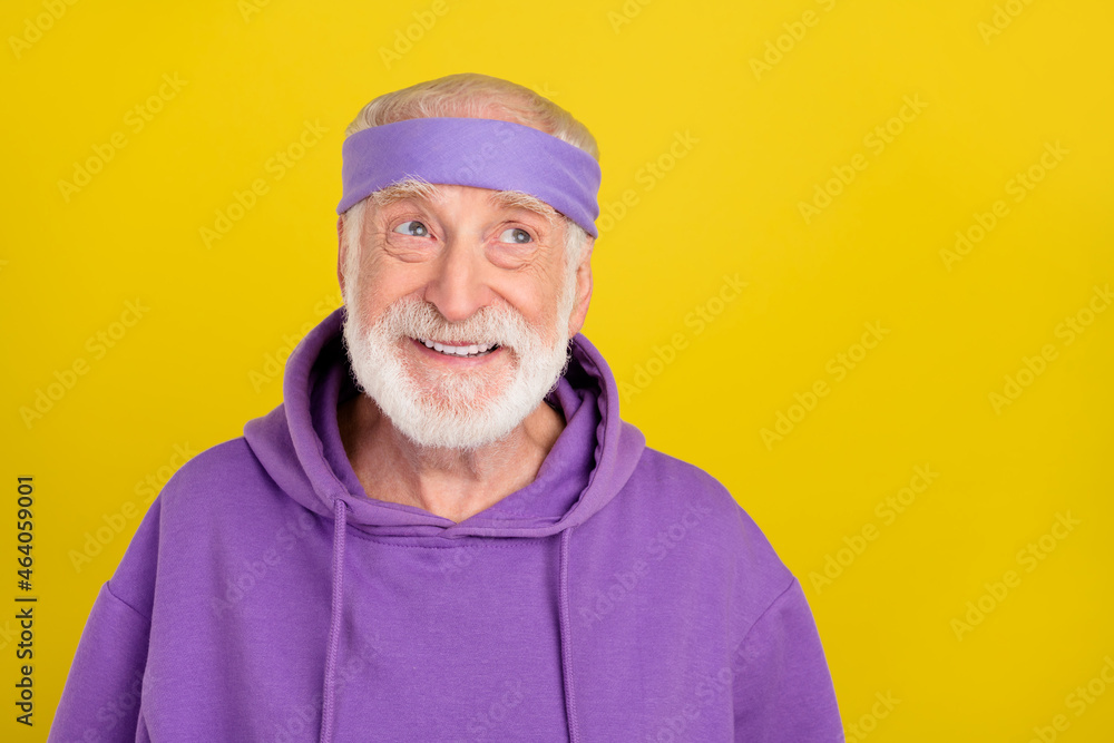 Photo of cheerful aged man wondered look empty space hmm creative isolated over yellow color background