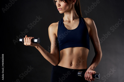 athletic woman fitness exercise dumbbells in the hands of Strong studio gym © SHOTPRIME STUDIO