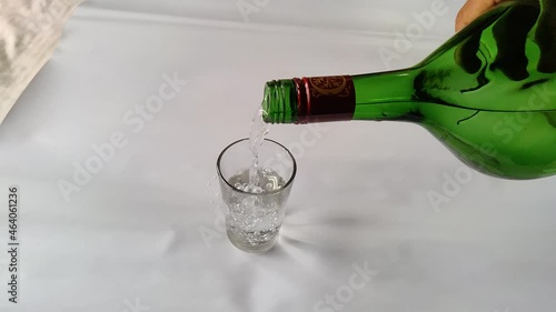 Pouring drinks from the bottle to the glass slow motion closeup shot