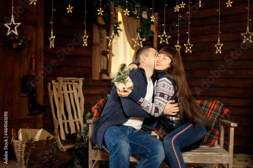 Young couple in love spend Christmas night together enjoying each other
