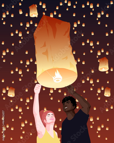 Interracial people holding Asian sky lantern at night