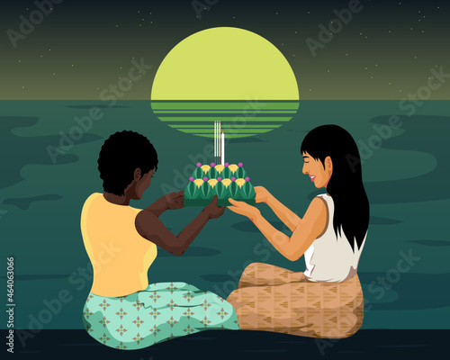 Couple floating traditional lantern on religious holiday photo