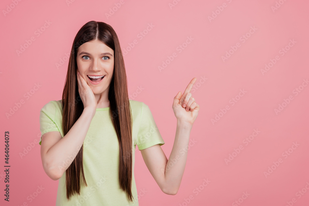 Portrait of young charming attractive cheerful girl pointing finger empty space advert advice isolated over pink background Portrait of young charming attractive cheerful girl pointing finger empty space advert advice isolated over pink background
