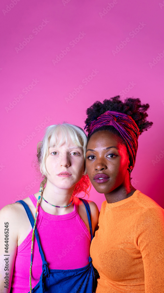 Isolated caucasian and black woman posing together for inclusion and tolerance Isolated caucasian and black woman posing together for inclusion and tolerance