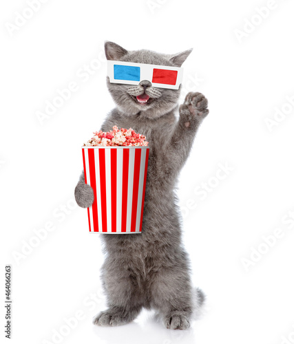 Happy cat wearing 3d glasses holfd basket of popcorn. isolated on white background