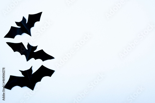 Halloween white background with black bats. View from above. Holiday decorations concept. Copy space, top view, flat lay. DIY