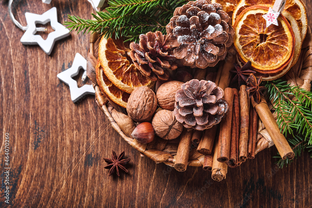 Dry orange, star anise, cinnamon, pine cones and fir tree in rustic plate  on wooden table. Homemade medley idea for Christmas mood and aroma. Eco  friendly christmas with homemade natural decorations. Stock