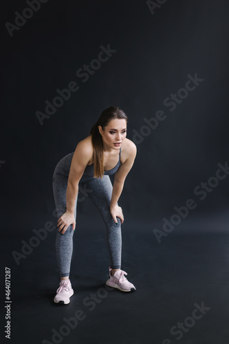 Confident pose of fitness trainer portrait. Woman in sportswear. Strong beautiful sportswoman with make-up. The owner of the gym. Lifestyle. Sportive curvy girl with a muscular figure. Healthy 