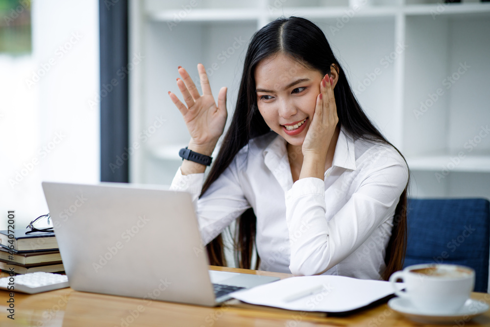 Young Business Asian woman in having a video call on a laptop computer. Young Business Asian woman in having a video call on a laptop computer.