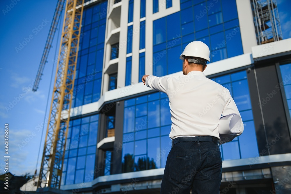 A construction worker control a pouring concrete pump on construction site and sunset background A construction worker control a pouring concrete pump on construction site and sunset background