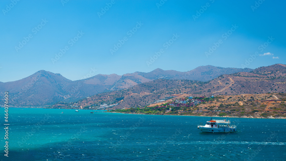 the blue sea of Greece against the background of mountains in sunny weather