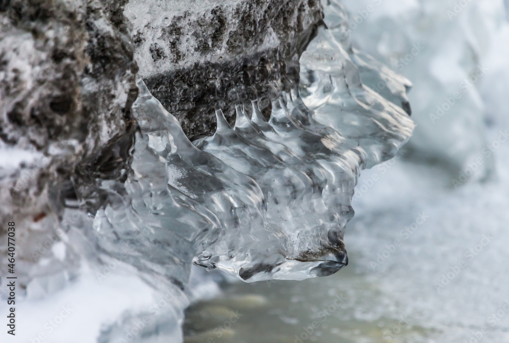 Icicles and frost on a snow-covered frozen river Icicles and frost on a snow-covered frozen river