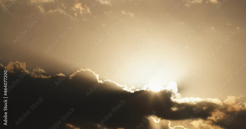The sun appears on top of fast moving clouds by sunset, the Netherlands. The sun appears on top of fast moving clouds by sunset, the Netherlands.