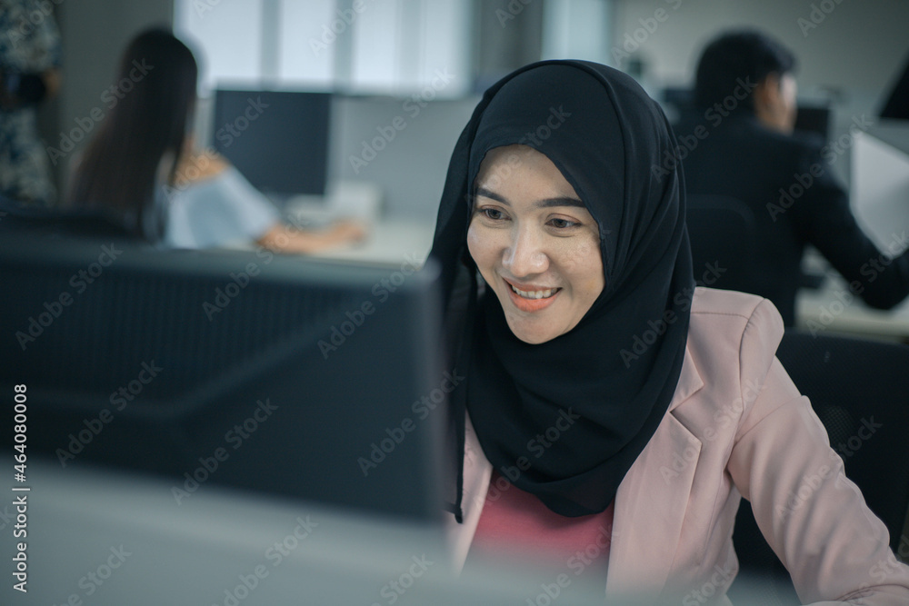 Happy muslim asian woman working and using pc at office meeting Happy muslim asian woman working and using pc at office meeting