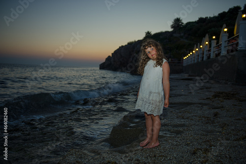 woman walking on the beach at sunset © Anastasia