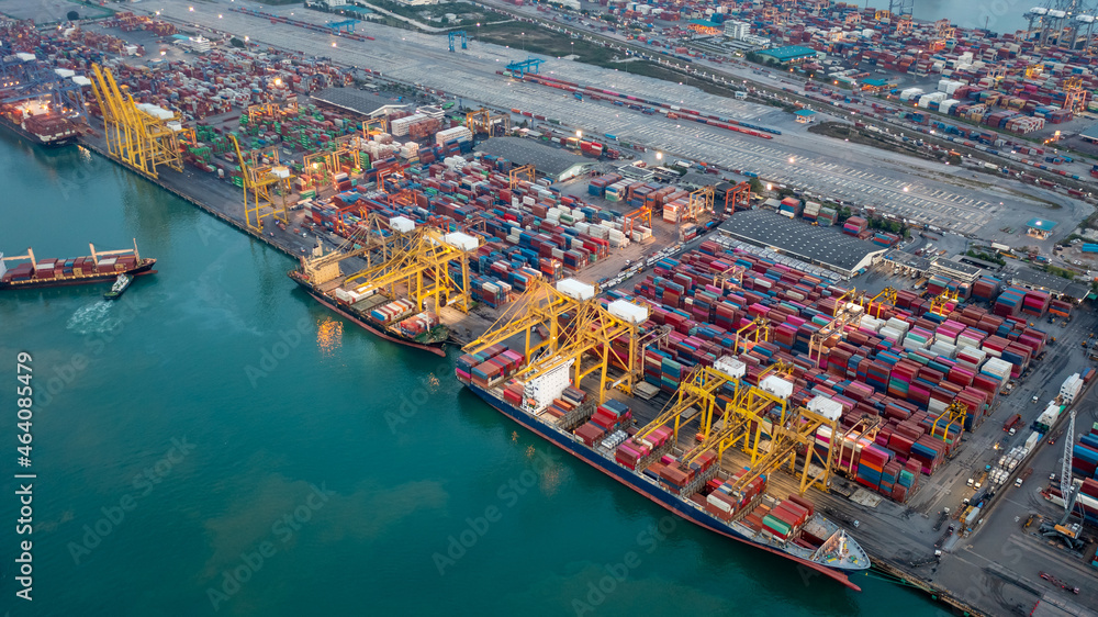 Aerial high angle view of container cargo ship and shipping port in the export and import industry business services and logistics international goods in urban city. Shipping to the harbor by crane