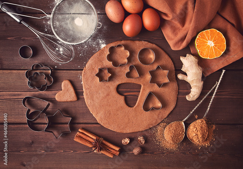 Raw dough, Cookie cutter and gingerbread ingredients, on a wooden table, top view, flat layout, selective focus, vintage tinting, no people,