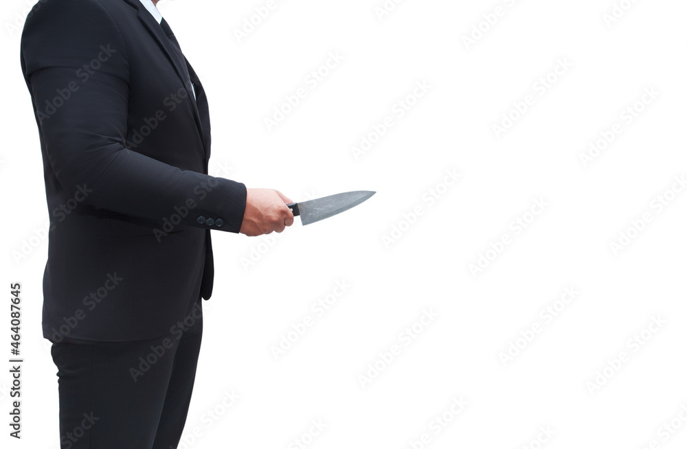 A businessman in a black suit stands holding a knife ready to attack his target. On a lonely white background, businessman murder. A businessman in a black suit stands holding a knife ready to attack his target. On a lonely white background, businessman murder.