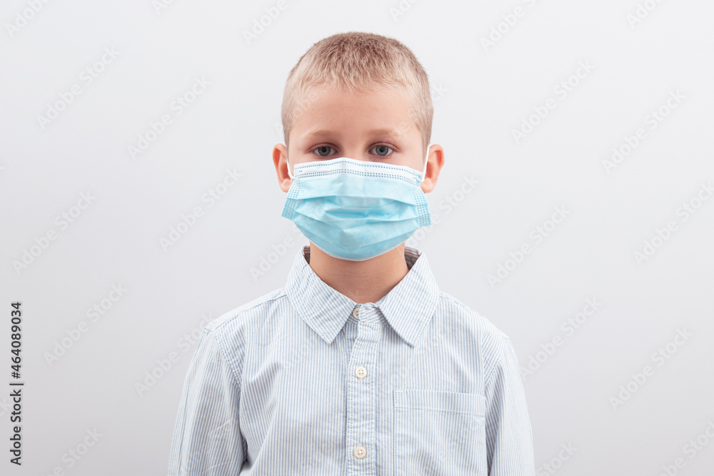 Portrait of an upset boy wearing a medical mask Portrait of an upset boy wearing a medical mask