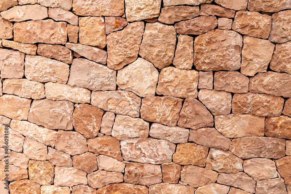 Fototapeta premium Light brown sandstone wall, stone wall background.