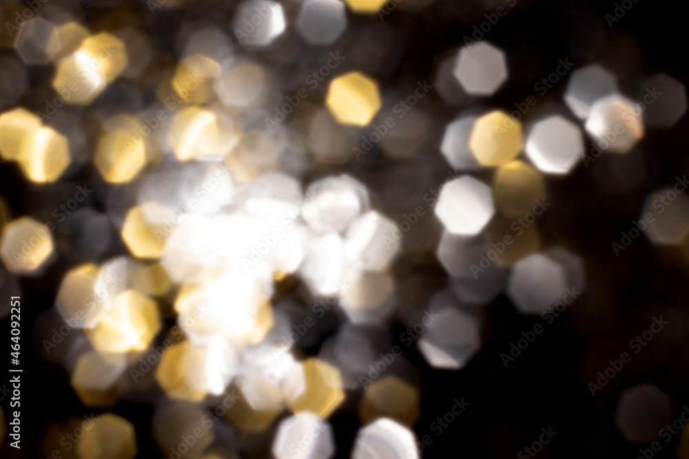 Golden and silver blurred bokeh lights on black background. Glitter sparkle stars for celebrate. Overlay for your design