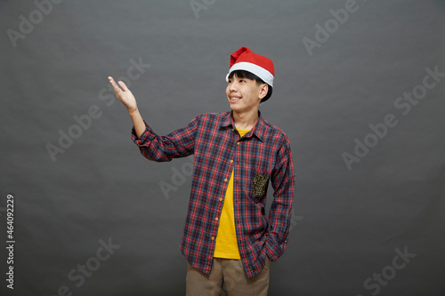 Portrait young asian man wear santa hat