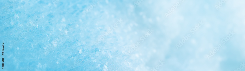 Snowy background with closeup view of the crystal snowflakes