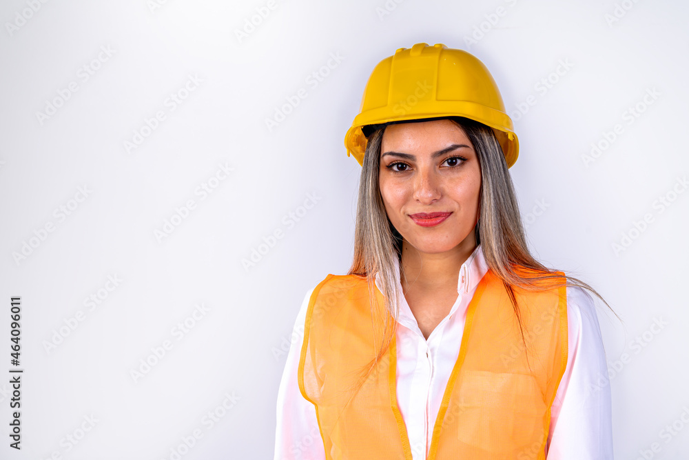 Beautiful young female engineer or supervisor, wearing safety equipment, on white background with room for text or copy space. Concept of empowered woman, professional woman, professional job. Beautiful young female engineer or supervisor, wearing safety equipment, on white background with room for text or copy space. Concept of empowered woman, professional woman, professional job.